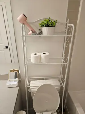 a bathroom with a toilet with three rolls of toilet paper at Emeka & Comfort in Calgary