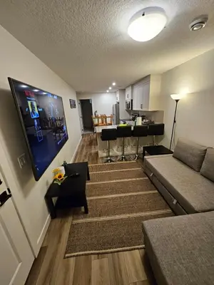 a living room with a couch and a video game at Emeka & Comfort in Calgary