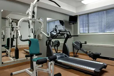 a gym with a treadmill and a tread machine at Days Inn by Wyndham Whitecourt in Whitecourt