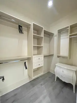 a bathroom with white cabinets and a sink and a desk at Vancouver Airport Love Home Inn in Richmond