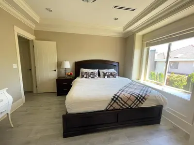 a bedroom with a large bed and a window at Vancouver Airport Love Home Inn in Richmond