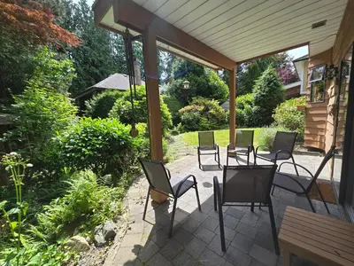 a group of chairs sitting on a patio at Luxury 3BR Home, 2 King Beds, Near cafes and groceries in North Vancouver