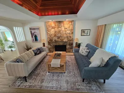 a living room with two couches and a fireplace at Luxury 3BR Home, 2 King Beds, Near cafes and groceries in North Vancouver