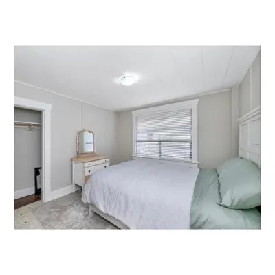 a bedroom with a bed and a window at Youbou Lakefront Getaway Relax And Unwind in Youbou