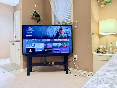 a flat screen tv on a stand in a bedroom at Scorpio House Langley in Langley