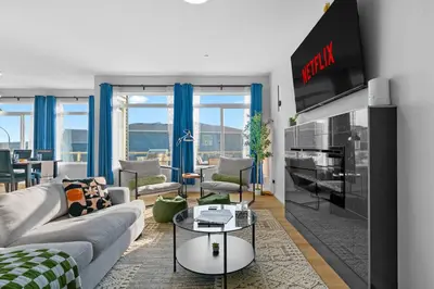 a living room with a couch and a tv at The Ultimate Getaway with Central AC, 3 King Beds, Hot Tub, Pool Table and More in Balzac