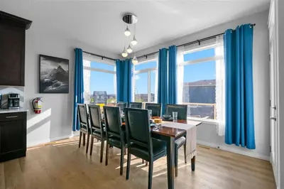 a dining room with blue curtains and a table and chairs at The Ultimate Getaway with Central AC, 3 King Beds, Hot Tub, Pool Table and More in Balzac