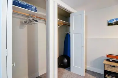 a closet with a door and a surfboard at Viewtiful Stay in Ladysmith