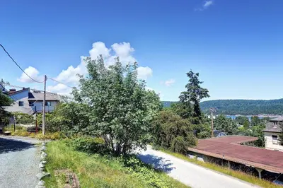 a house with a wooden roof next to a road at Viewtiful Stay in Ladysmith