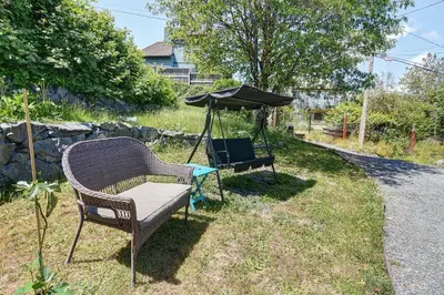 a chair and an umbrella sitting in the grass at Viewtiful Stay in Ladysmith