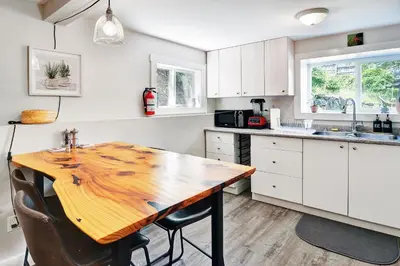 a kitchen with a wooden table and some chairs at Viewtiful Stay in Ladysmith
