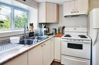 a white kitchen with a sink and a stove at Viewtiful Stay in Ladysmith
