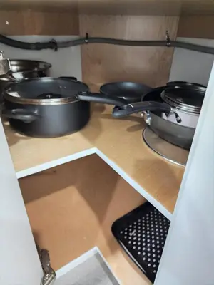 a shelf with pots and pans in a kitchen at Gorgeous Two Bedroom Suite in a Quiet, Picturesque Neighborhood! in West Vancouver