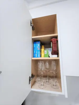 a cupboard with wine glasses in it at Gorgeous Two Bedroom Suite in a Quiet, Picturesque Neighborhood! in West Vancouver