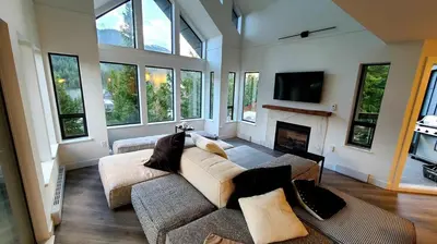 a living room with a couch and a fireplace at Ravencrest 204 by Outpost Whistler in Whistler