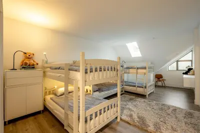 a bedroom with two bunk beds and a desk at Ravencrest 204 by Outpost Whistler in Whistler