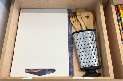 a wooden drawer with a cutting board and knife at RomanticStylish|FreeWifi|KingBed|WEM|parking in Edmonton