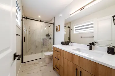 a bathroom with a shower and a sink and a toilet at ~CozySpacious3bedroomRetreat~FREEparking•2.5bath in Edmonton