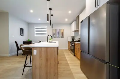 a kitchen with a counter and a refrigerator at ~CozySpacious3bedroomRetreat~FREEparking•2.5bath in Edmonton