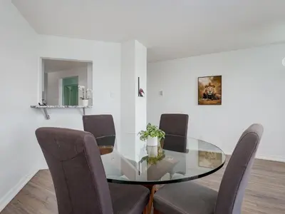 a dining room with a glass table and chairs at Coastal Duet - min 3-Day Stay Breathtaking Views with Work Desk by Victoria Prime! in Victoria