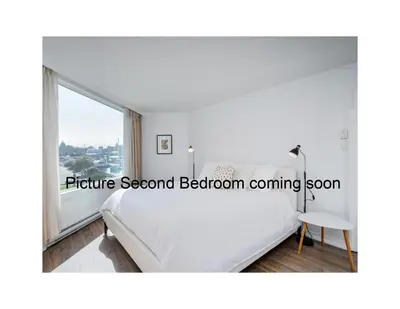 a bedroom with a white bed and a large window at Coastal Duet - min 3-Day Stay Breathtaking Views with Work Desk by Victoria Prime! in Victoria
