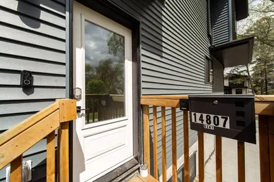 a front door of a house with a sign on it at ~SweetTropicalBSMTsuite~KingBed|WIFI•parking in Edmonton