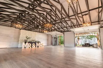 a large ballroom with a dance floor with a mr and mrs sign at Prairie Junction Rustic Cabins Stettler in Stettler