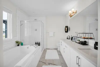 a white bathroom with a shower and a sink at New Luxury Sleeps 7 AC Double Garage in Edmonton