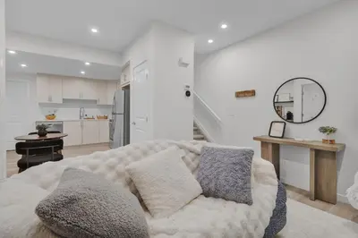 a living room with a couch and a kitchen at 1 BR Suite Stylish Coffee Station Stocked sleep 4 in Edmonton