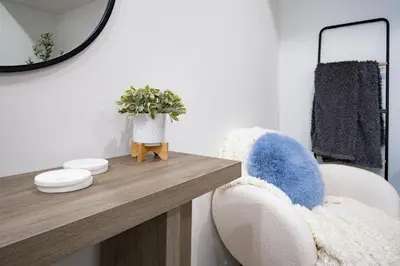 a living room with a table and chairs and a mirror at 1 BR Suite Stylish Coffee Station Stocked sleep 4 in Edmonton