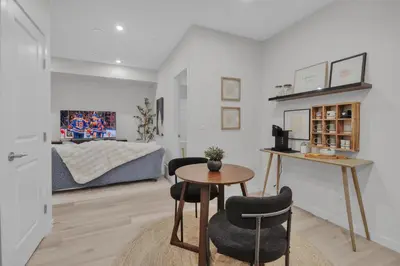 a living room with a table and two chairs and a bed at 1 BR Suite Stylish Coffee Station Stocked sleep 4 in Edmonton