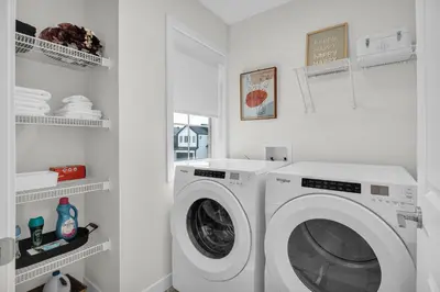 a white laundry room with a washing machine at Trendy & Spacious Sleeps 9 AC Db Garage in Edmonton