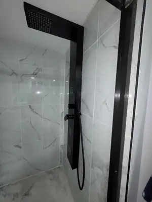 a shower with a glass door in a bathroom at Gorgeous Basement Apartment in Calgary