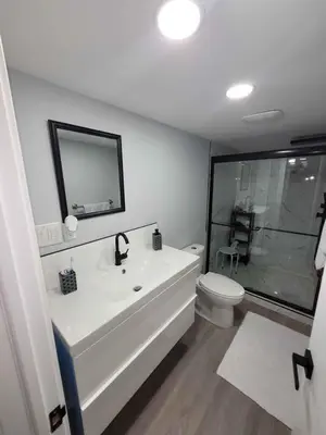 a bathroom with a tub and a toilet and a sink at Gorgeous Basement Apartment in Calgary