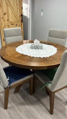 a wooden table with chairs and a plate on it at Gorgeous Basement Apartment in Calgary