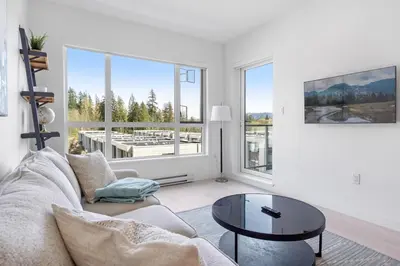 a living room with a couch and a table at Modern North Shore Nest with Balcony in North Vancouver