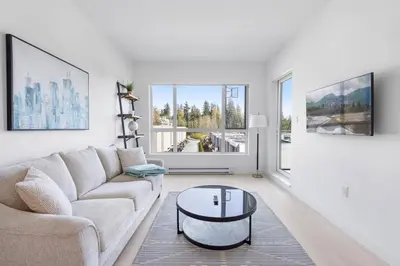 a living room with a couch and a coffee table at Modern North Shore Nest with Balcony in North Vancouver