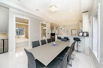 a dining room with a white table and chairs at Upscale 4BR Vancouver in Vancouver