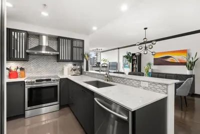a kitchen with a sink and a stove at Large 1br Sub-Penthouse Near Science World in Vancouver