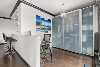 an office with a desk and chairs and windows at Large 1br Sub-Penthouse Near Science World in Vancouver