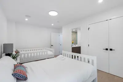 a white bedroom with a white bed and a closet at 2505 Edgemont Blvd.- Anupoju in North Vancouver