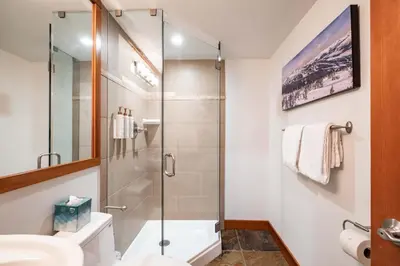 a bathroom with a glass shower and a sink at Ravencrest 309 by Outpost Whistler in Whistler