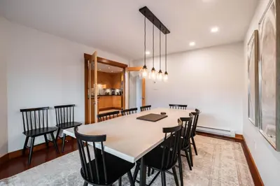 a dining room with a large table and chairs at Ravencrest 309 by Outpost Whistler in Whistler
