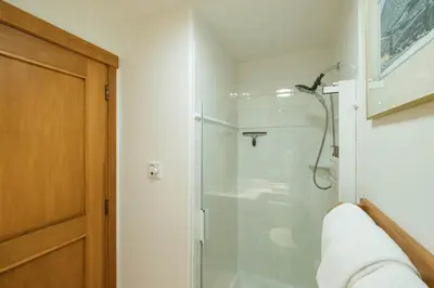 a bathroom with a shower with a glass door at Taluswood 6 by Outpost Whistler in Whistler