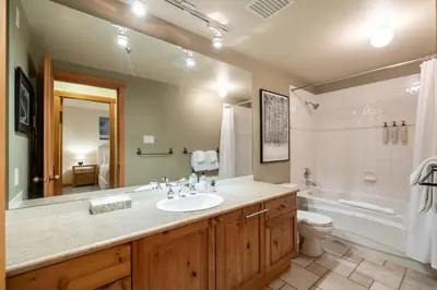 a bathroom with a sink and a tub and a toilet at Taluswood 14 by Outpost Whistler in Whistler