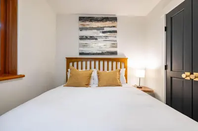 a bedroom with a large white bed with two pillows at Taluswood 36 by Outpost Whistler in Whistler