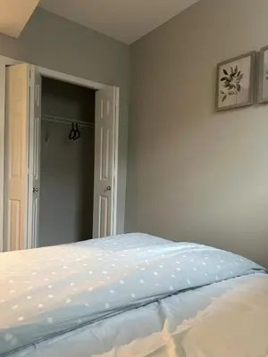 a bedroom with a bed with a white bedspread at Oisede in Edmonton