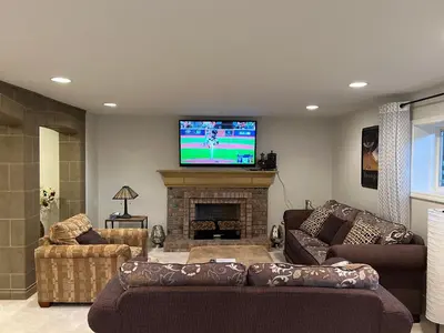 a living room with couches and a flat screen tv at The McCleery Inn in Vancouver