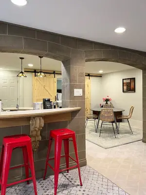 a kitchen with two red bar stools and a table at The McCleery Inn in Vancouver