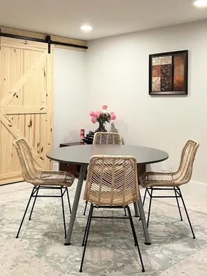 a table with chairs and a vase of flowers on it at The McCleery Inn in Vancouver